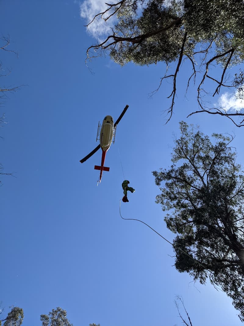 Project firefighter dripping out of helicopter in sky