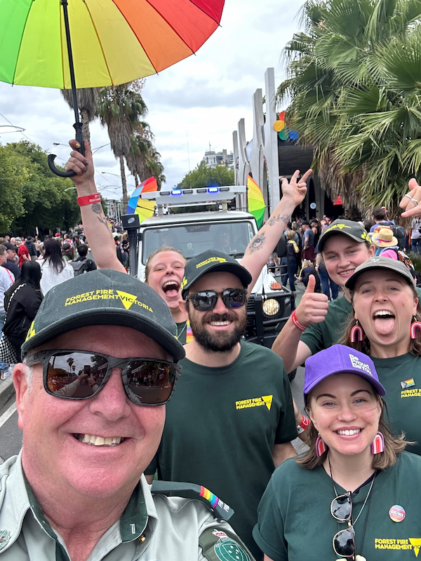 Chris at Pride Festival with staff in front of a fire truck
