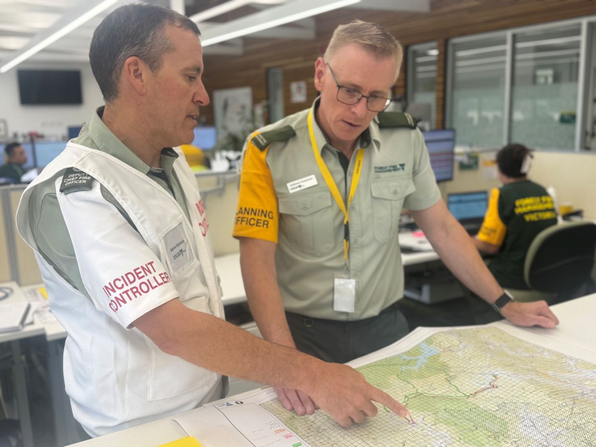 FFMVic Incident controller an plannir officer pointing to a map on a table