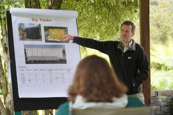 Nigel training and standing in front of a white board, women in foreground looking forward