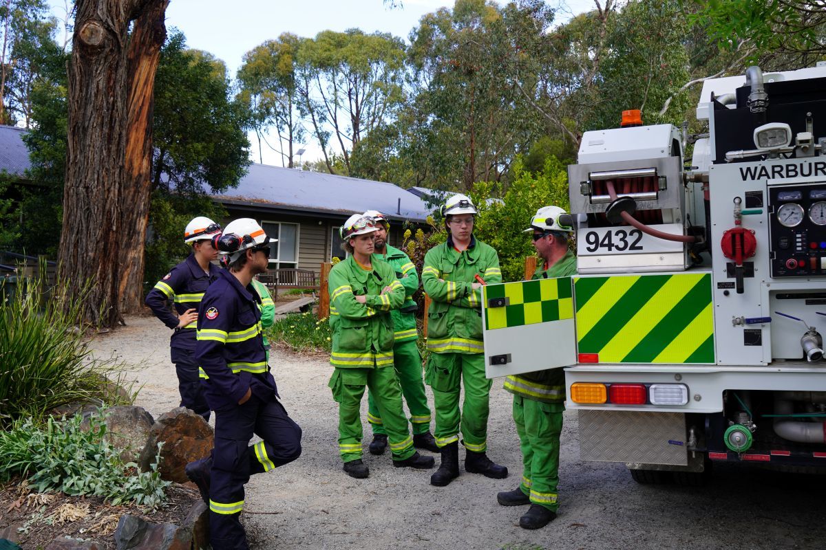 Trainees stand next to a FFMVic slip on track