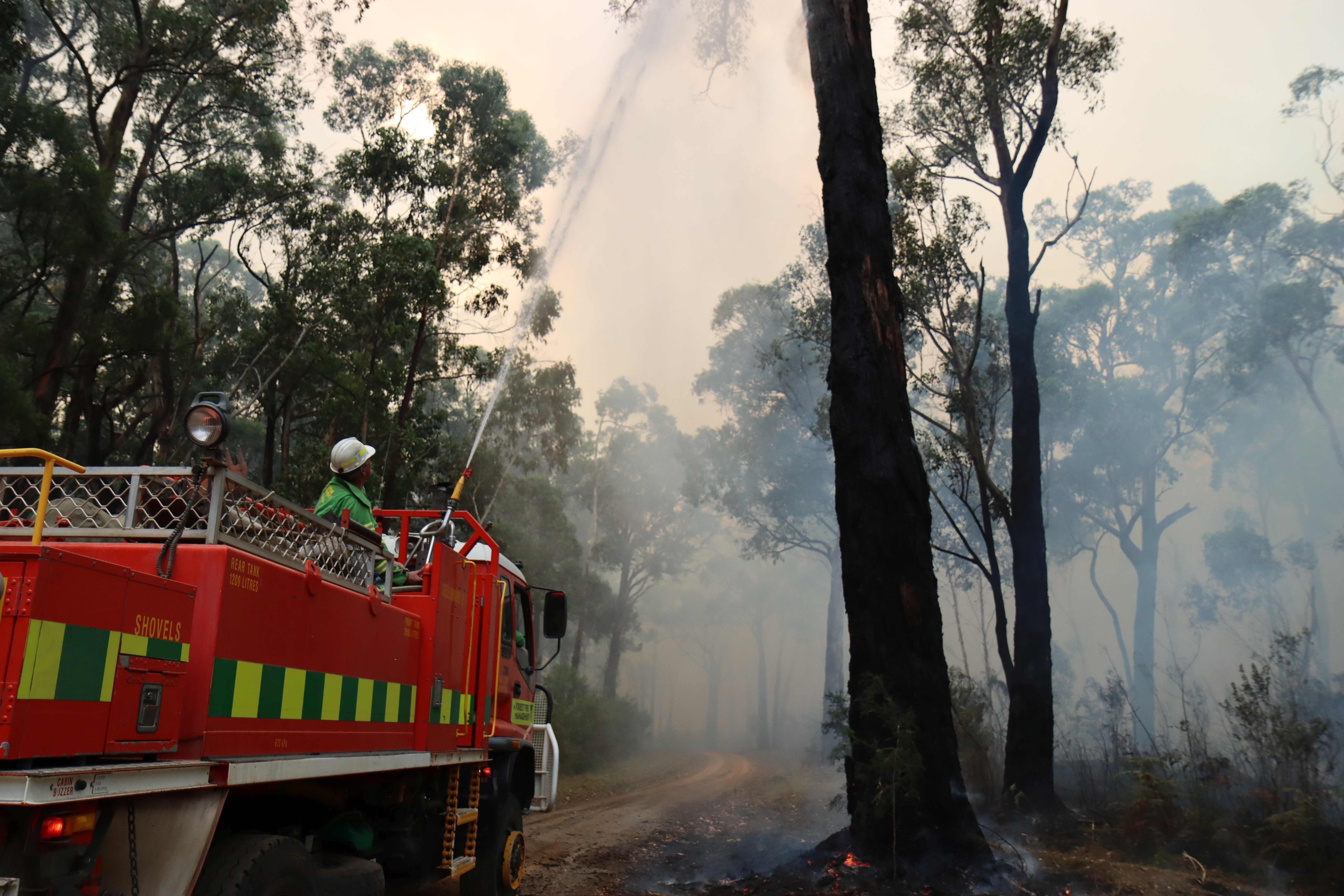 Freighters use a heavy tanker to extinguish a planned burn