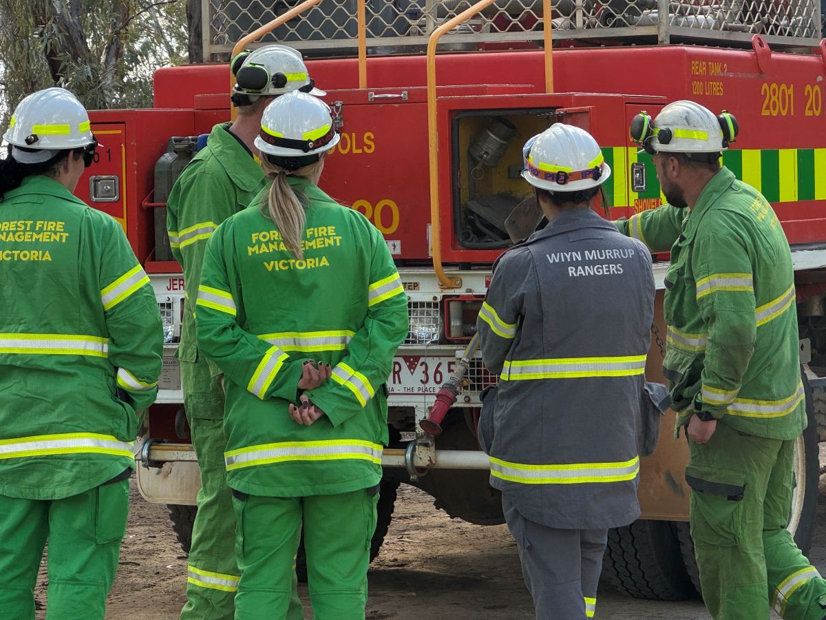 A group os trainees next to a red heavy tanker