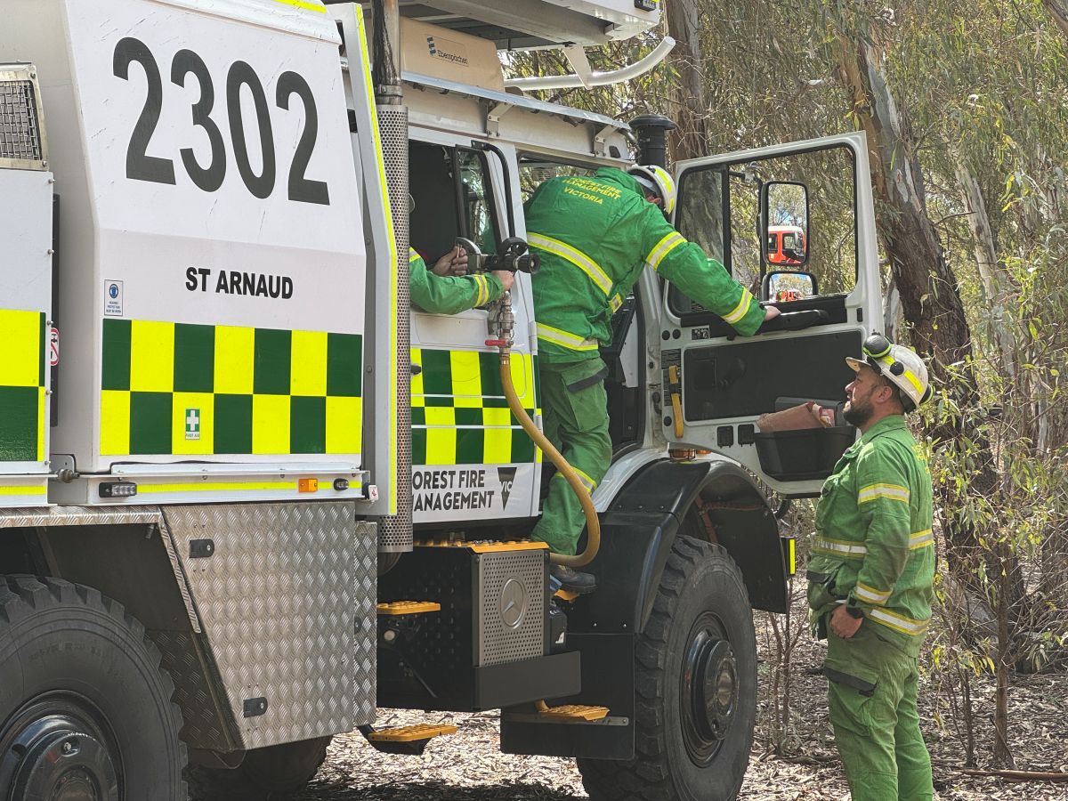 A trainee and his trainer in a Unimog