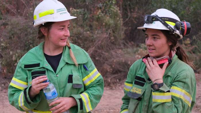 Two Project Firefighters standing next to each other. One is holding a bottle of water.