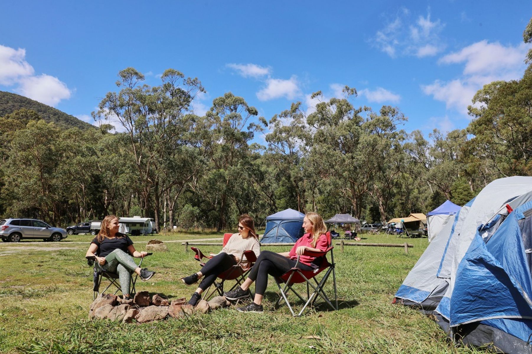 3 women sitting around a campsite at Kendalls campground