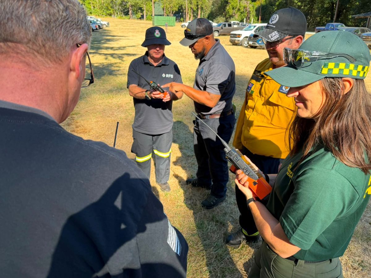 Firefighters looking at radios as part of training