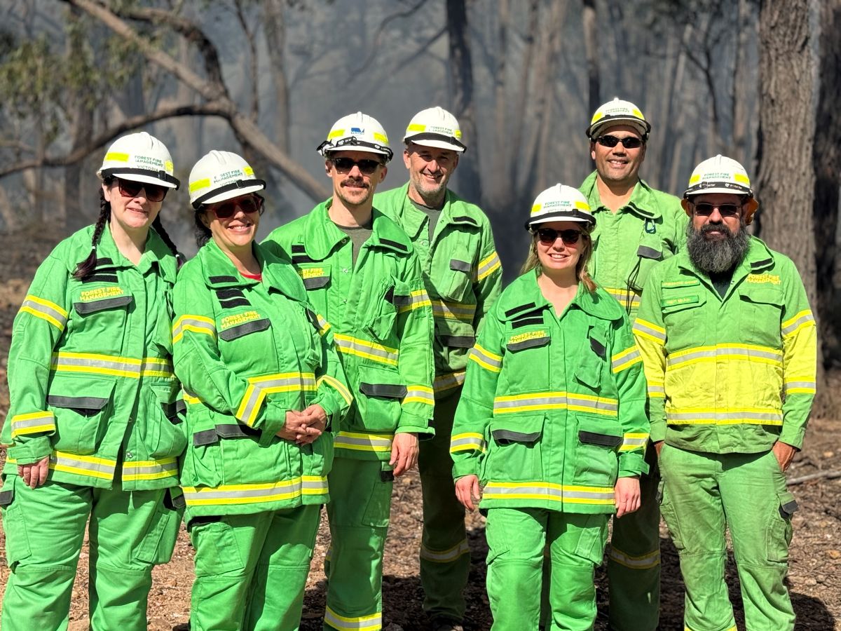 A group of four Canadians wearing FFMVic uniform, next to FFMVic team